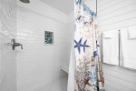 En-suite master bathroom walk in shower with a built-in sitting bench
